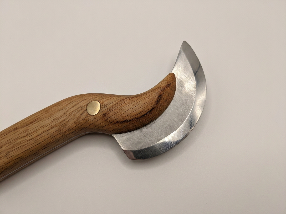 Close-up of the curved stainless steel blade
